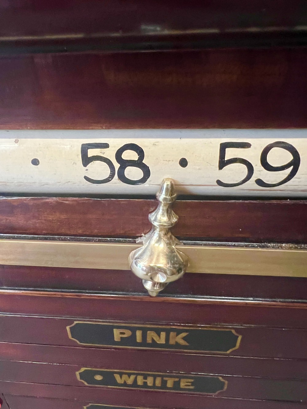 An antique dark mahogany snooker scoreboard featuring sliding pointer bars with coloured markers, brass fittings, and a central slate panel. View V