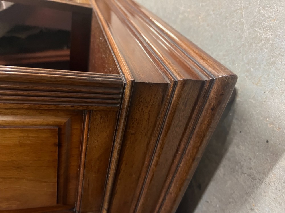 A four-sided warm brown wooden revolving bookcase featuring multiple tiers of open shelving, corner panel details, and a moulded top cornice. View VIII