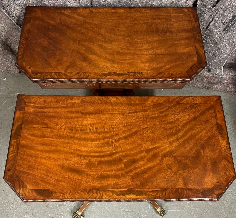 A pair of Regency flame mahogany fold-over card tables featuring boxwood inlay, reeded edges, and pedestal bases with splayed legs ending in brass paw castors. View III