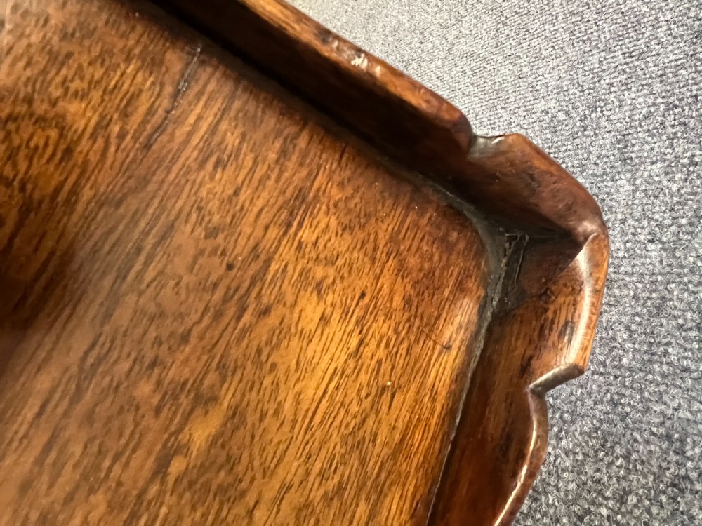 A Georgian mahogany silver table featuring a raised gallery top, a single drawer with brass handles, and slender cabriole legs. View II