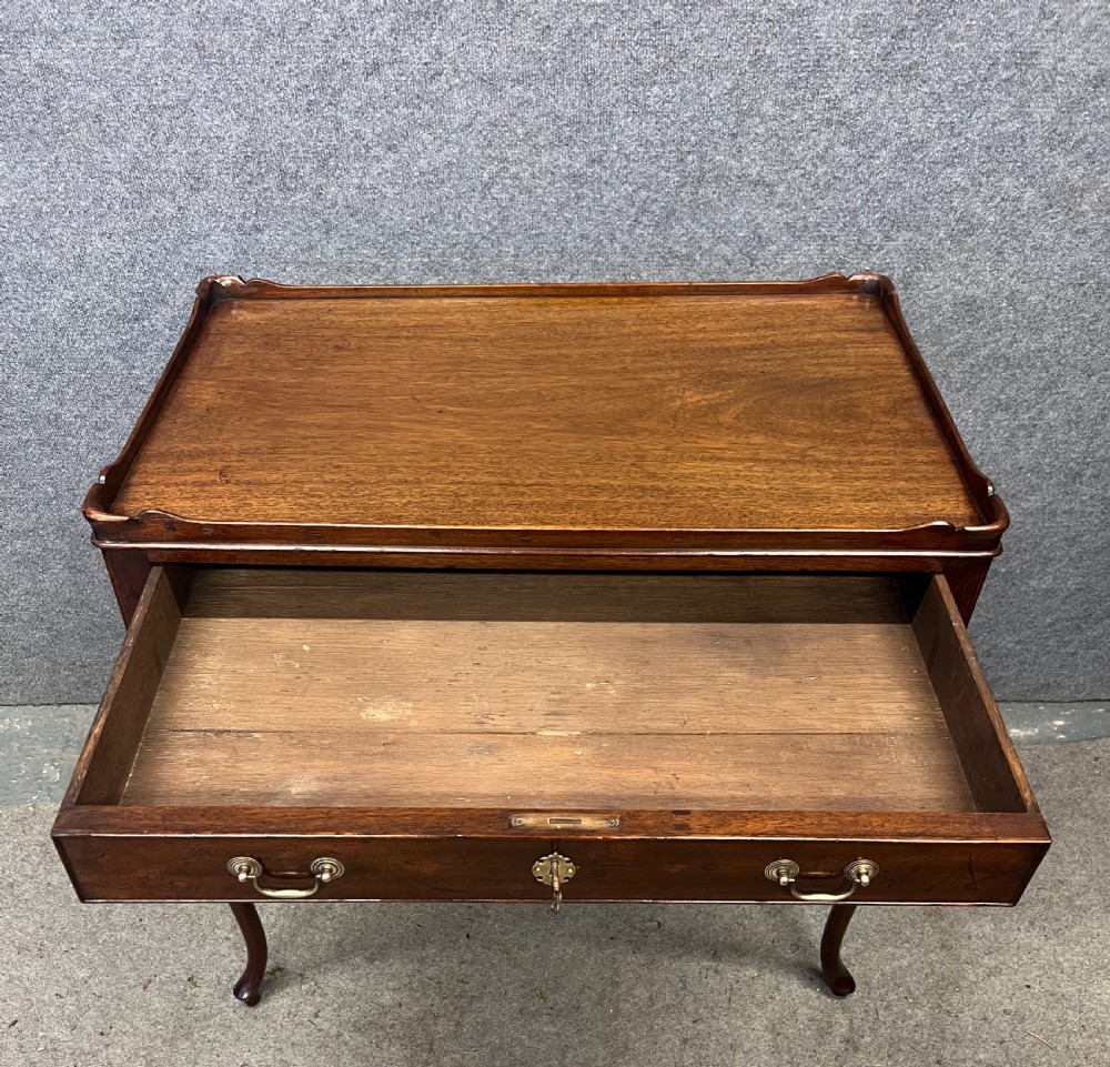 A Georgian mahogany silver table featuring a raised gallery top, a single drawer with brass handles, and slender cabriole legs. View IV