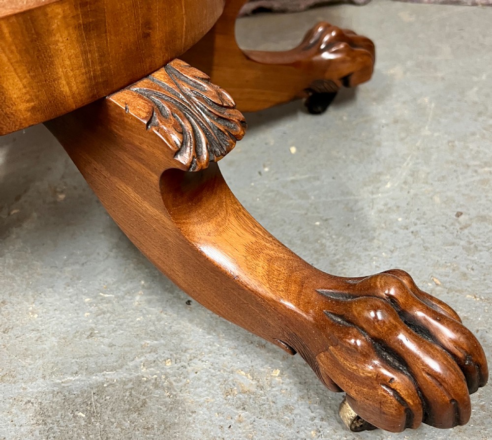 A pair of antique flame mahogany fold-over console tables featuring central carved pedestal columns and claw feet with castors. View VII