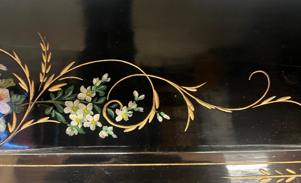 An Aesthetic Movement ebonised wooden overmantel mirror featuring hand-painted floral panels, gold foliage accents, and a curved top cresting. View III