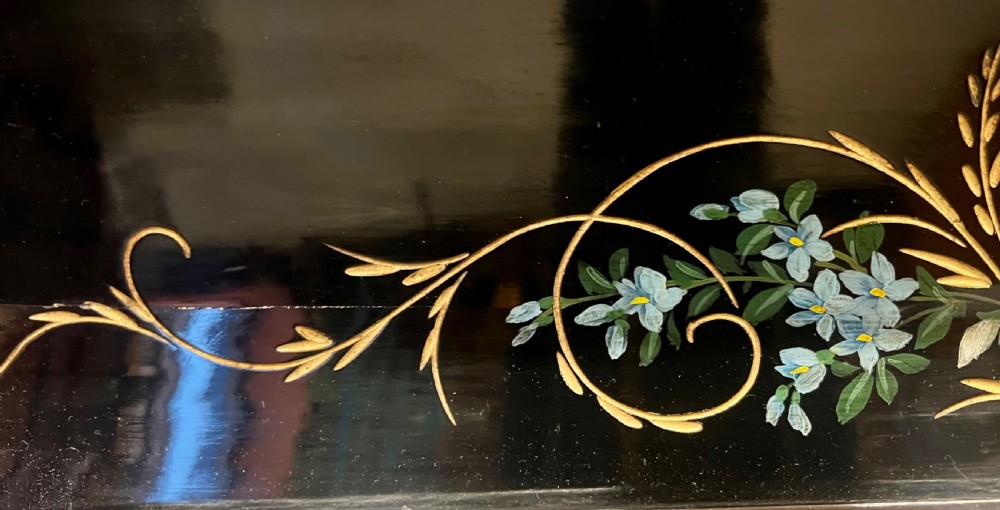 An Aesthetic Movement ebonised wooden overmantel mirror featuring hand-painted floral panels, gold foliage accents, and a curved top cresting. View IV