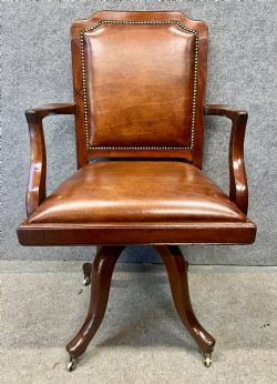 ANTIQUE MAHOGANY AND LEATHER UPHOLSTERED SWIVEL DESK CHAIR