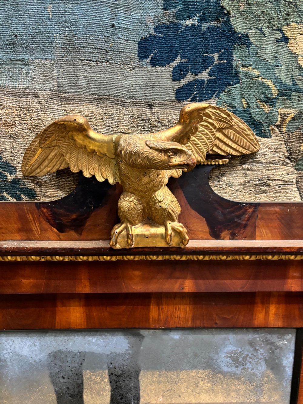 A rectangular Regency mahogany wall mirror with a carved gilded eagle cresting mounted at the top centre. View II