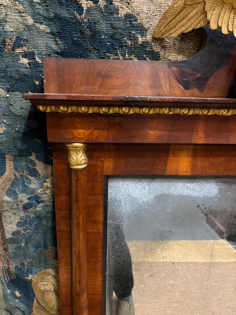 A rectangular Regency mahogany wall mirror with a carved gilded eagle cresting mounted at the top centre. View III