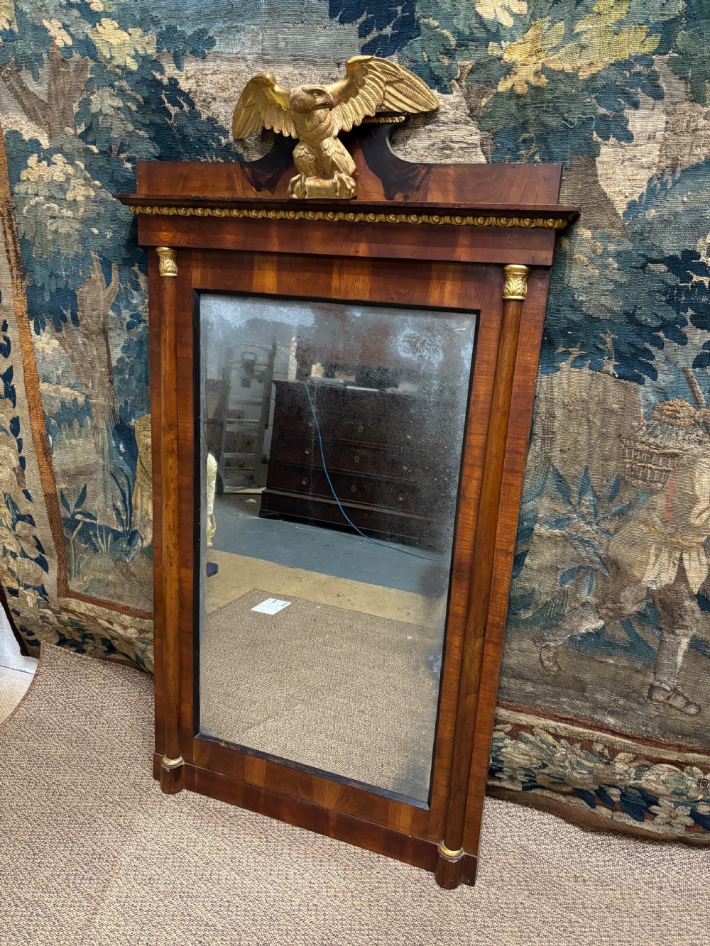 A rectangular Regency mahogany wall mirror with a carved gilded eagle cresting mounted at the top centre. View V
