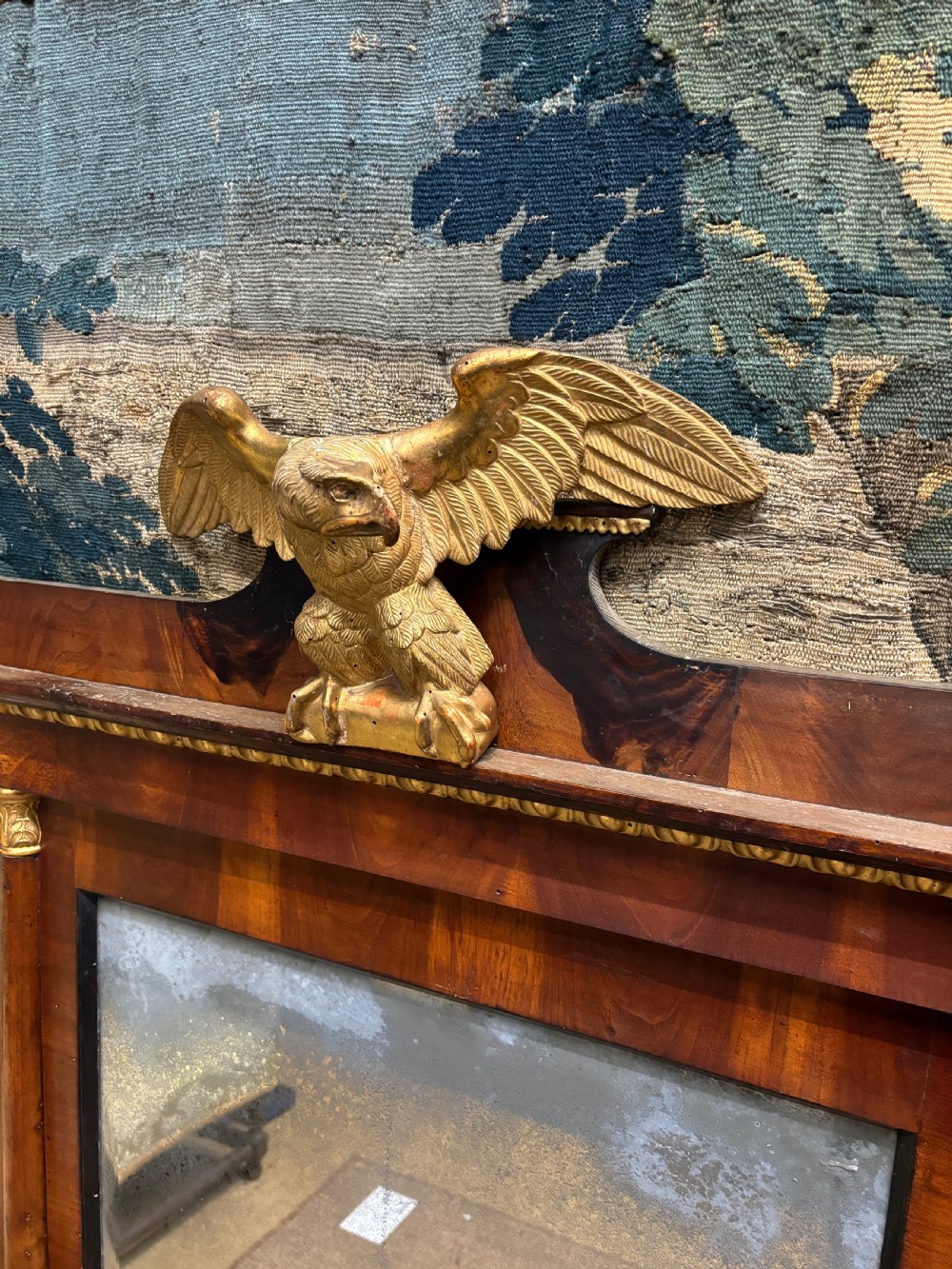 A rectangular Regency mahogany wall mirror with a carved gilded eagle cresting mounted at the top centre. View VI