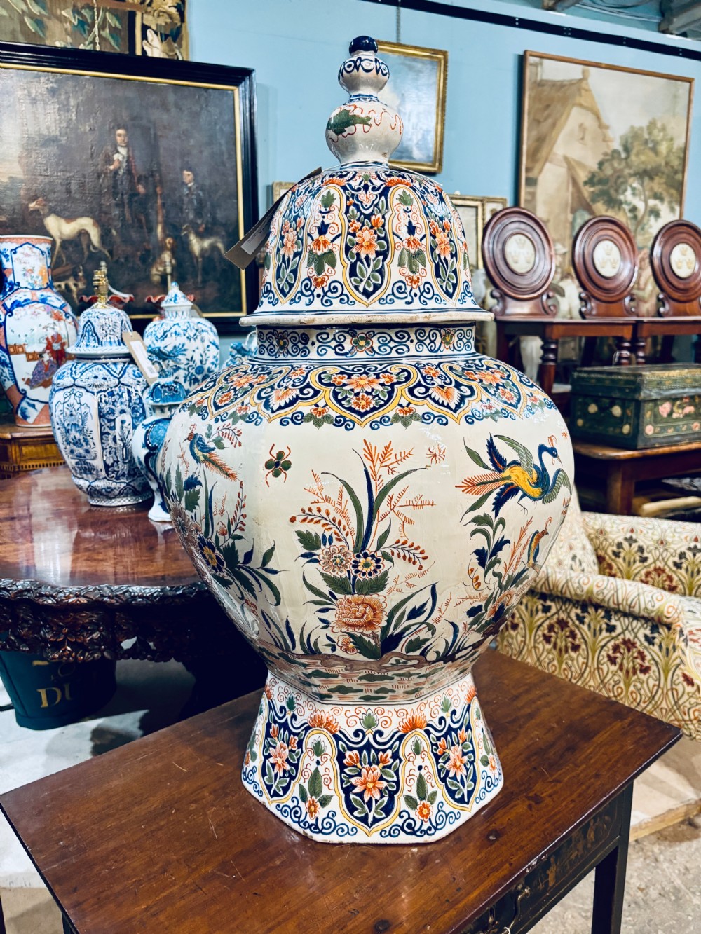 A large 19th-century polychrome Delft lidded jar decorated with hand-painted bird and floral patterns, featuring a domed lid with a finial. View III