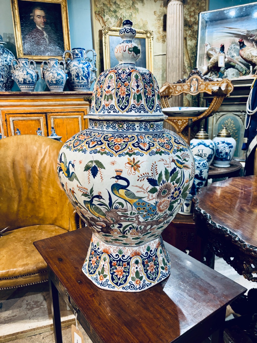 A large 19th-century polychrome Delft lidded jar decorated with hand-painted bird and floral patterns, featuring a domed lid with a finial. View V