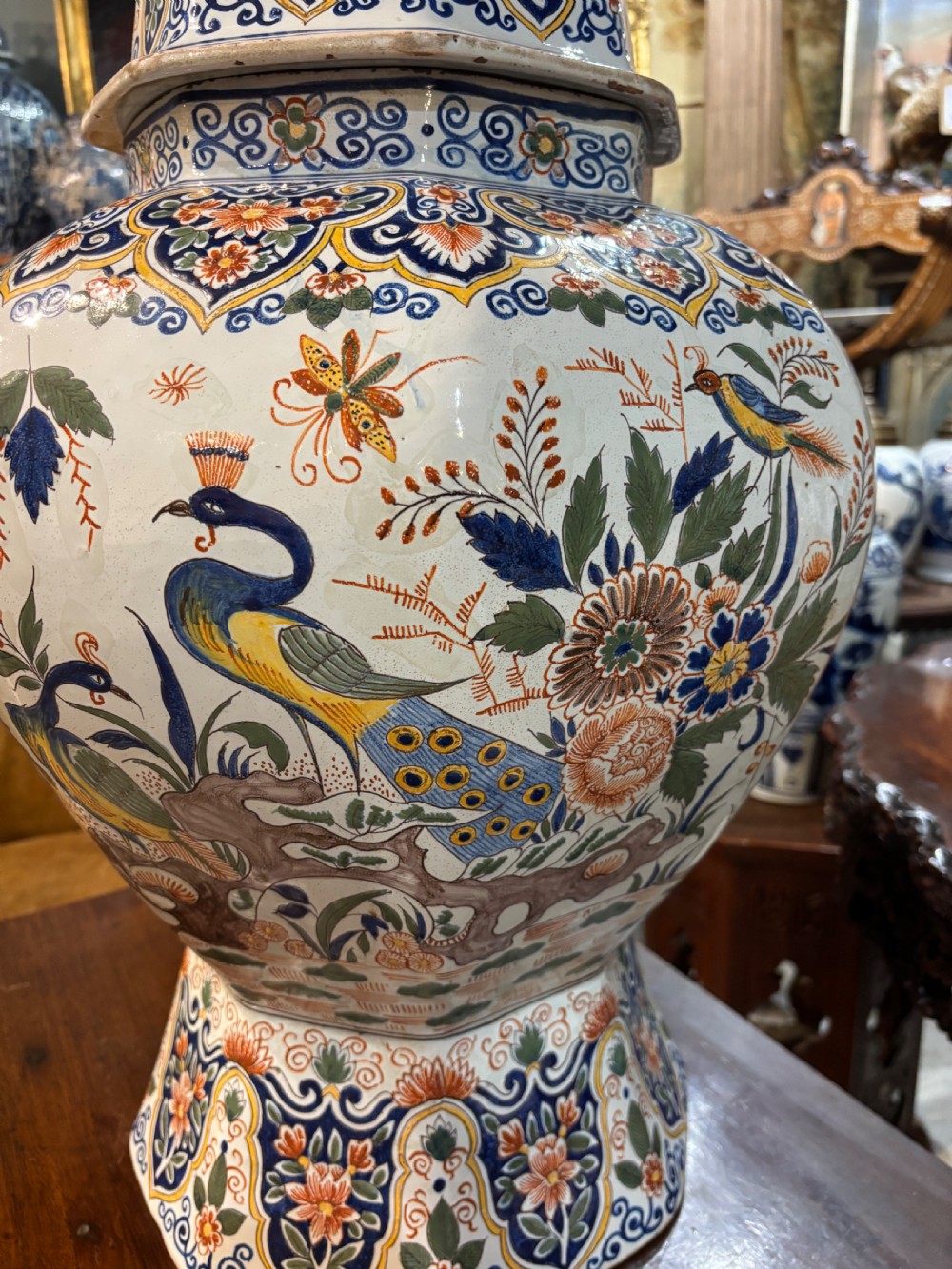 A large 19th-century polychrome Delft lidded jar decorated with hand-painted bird and floral patterns, featuring a domed lid with a finial. View VI
