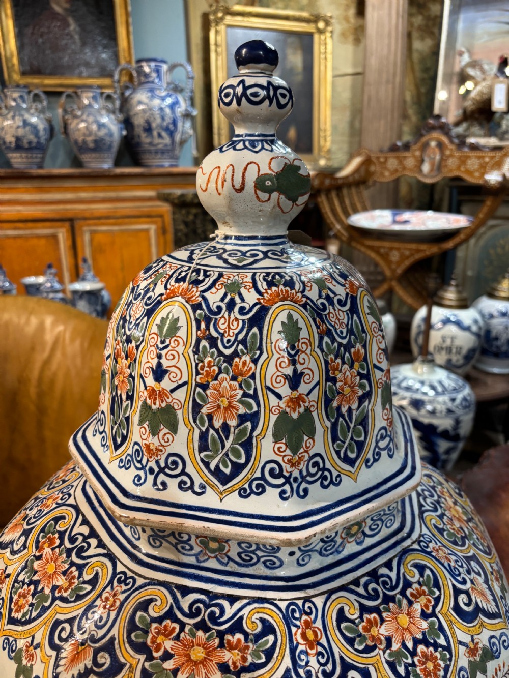 A large 19th-century polychrome Delft lidded jar decorated with hand-painted bird and floral patterns, featuring a domed lid with a finial. View VII