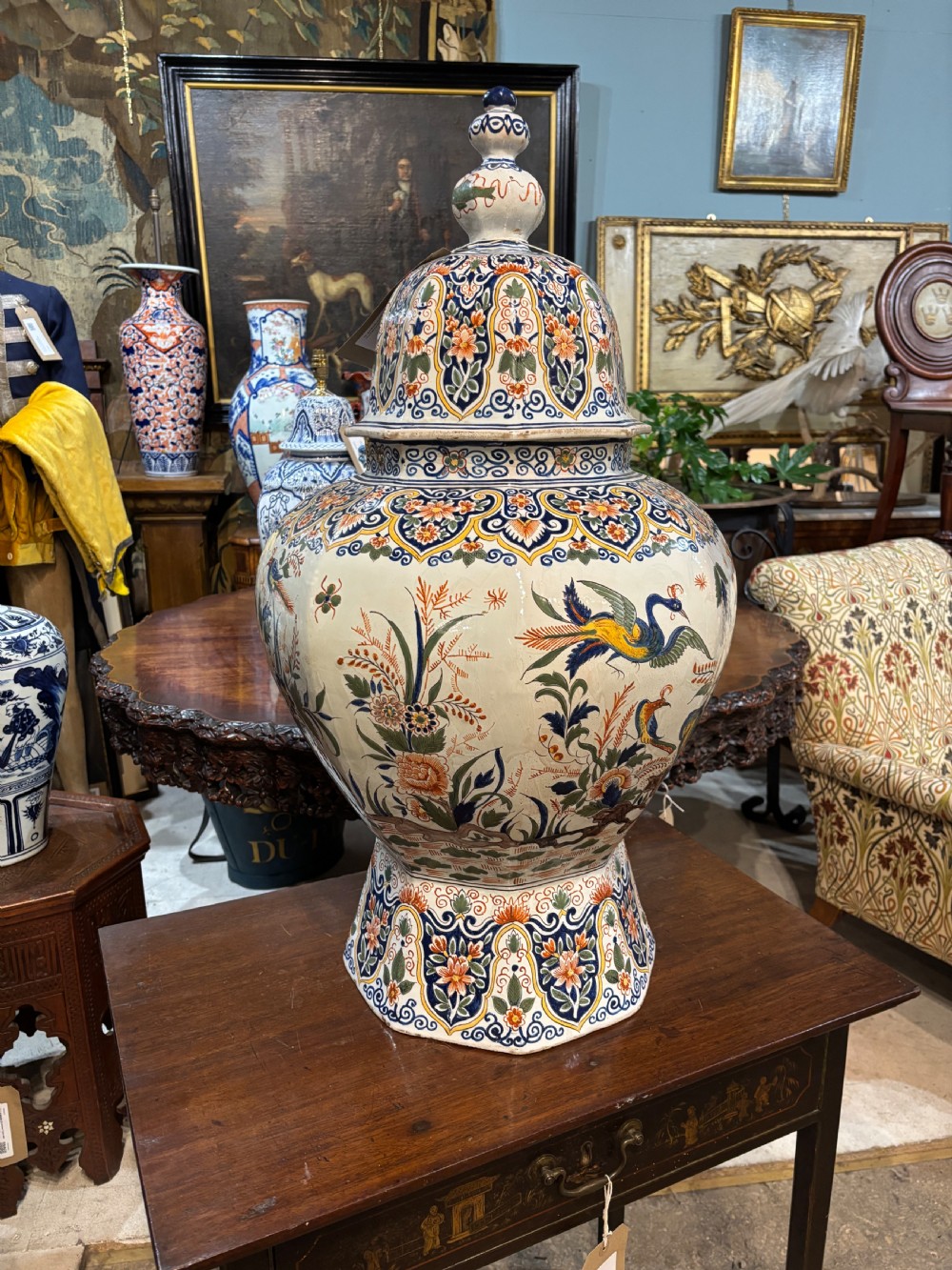 A large 19th-century polychrome Delft lidded jar decorated with hand-painted bird and floral patterns, featuring a domed lid with a finial. View VIII