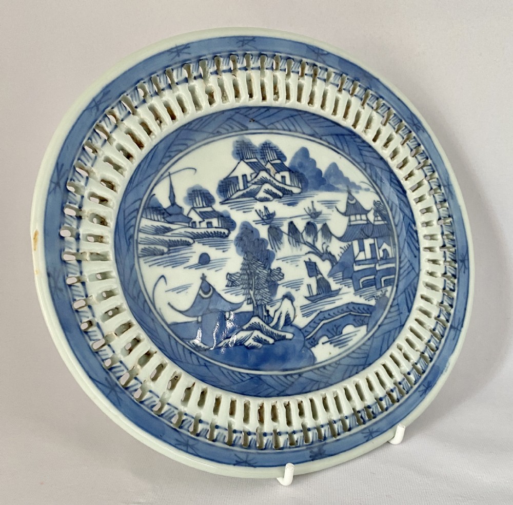 An oval blue and white porcelain Chinese export dish featuring a pierced reticulated border and a hand-painted landscape scene. View III