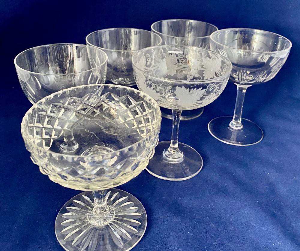 A set of six clear Edwardian stemware champagne coupes with assorted hand-cut and etched decorative patterns. View II