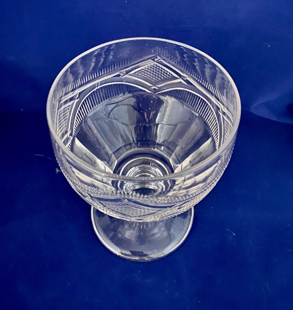 A large mid-Victorian clear cut glass rummer featuring a diamond pattern band above fluted cutting and a short knopped stem on a circular base. View III