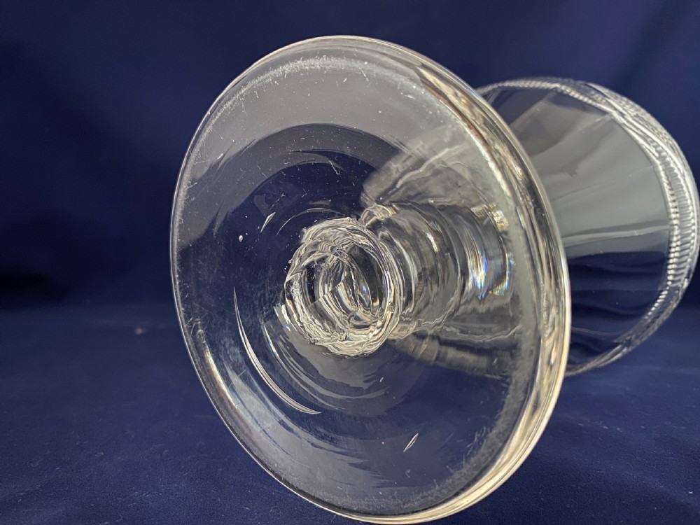 A large mid-Victorian clear cut glass rummer featuring a diamond pattern band above fluted cutting and a short knopped stem on a circular base. View V