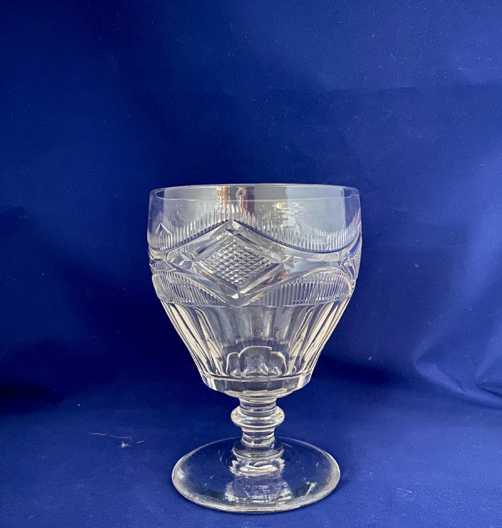 A large mid-Victorian clear cut glass rummer featuring a diamond pattern band above fluted cutting and a short knopped stem on a circular base. View VIII