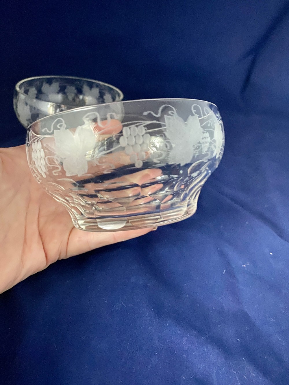 A pair of clear Victorian glass finger bowls with etched grape and vine motifs around the body and faceted cutting near the lower base. View III