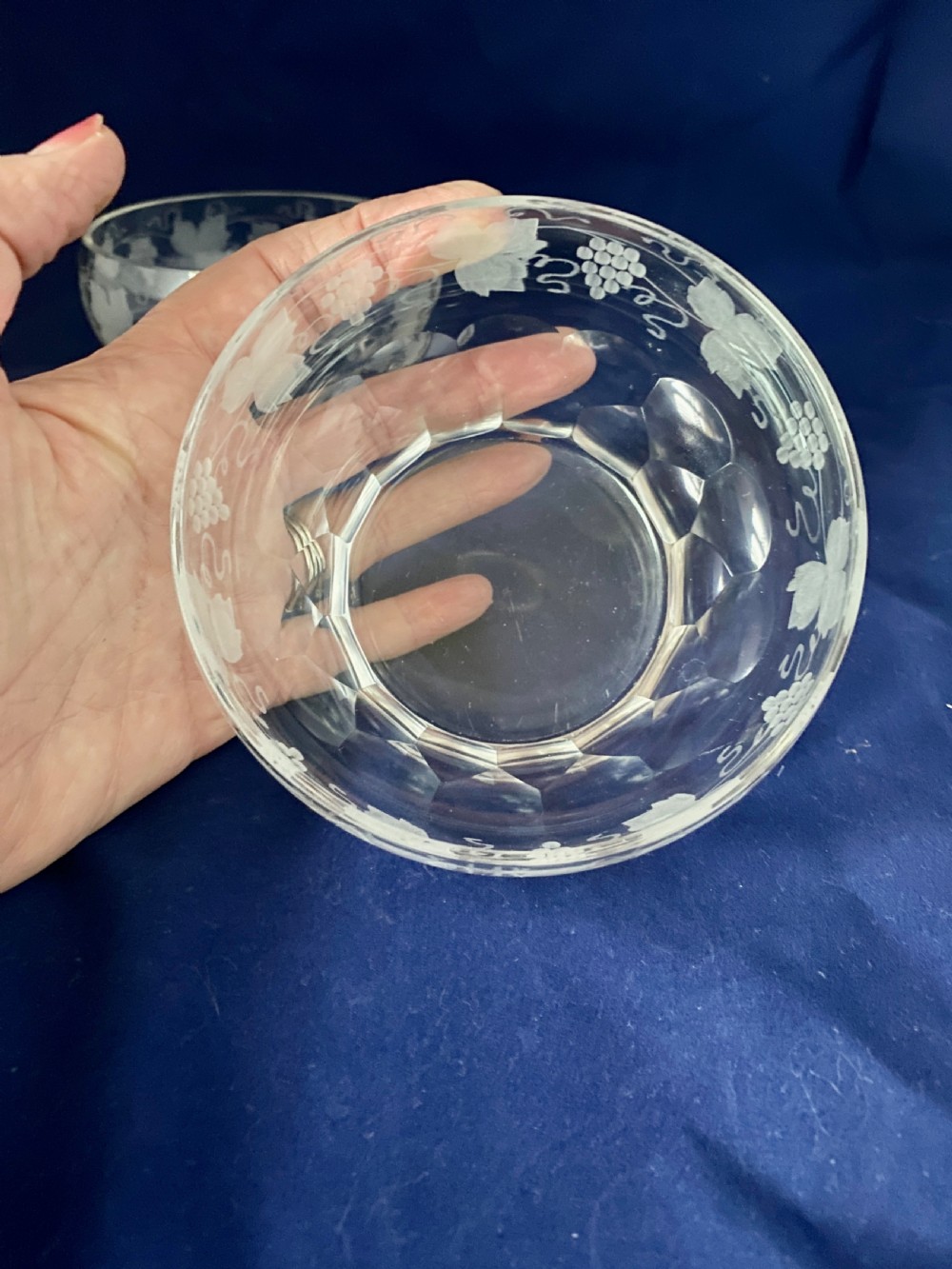A pair of clear Victorian glass finger bowls with etched grape and vine motifs around the body and faceted cutting near the lower base. View IV