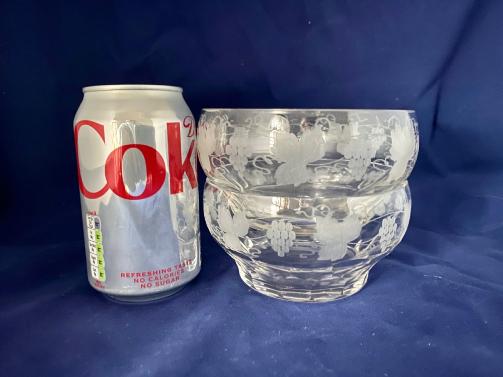 A pair of clear Victorian glass finger bowls with etched grape and vine motifs around the body and faceted cutting near the lower base. View V