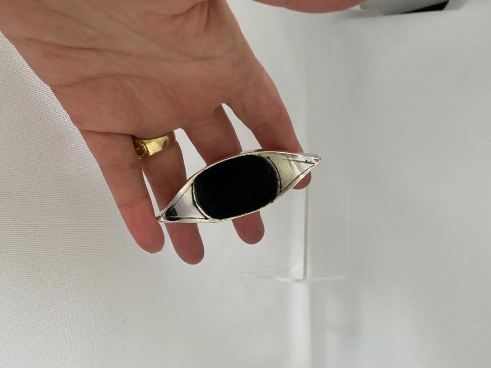 An Edwardian sterling silver pin cushion crafted in the shape of a canoe with a dark velvet insert and visible hallmarks on the exterior side. View V