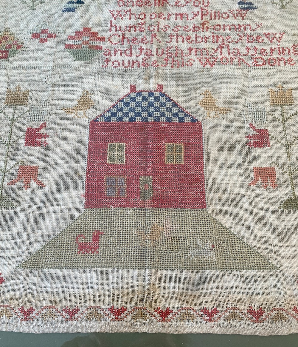 A framed 1839 Victorian needlework sampler featuring an embroidered verse, central house motif, floral trees, and the name Jane Dorrin on natural linen. View III