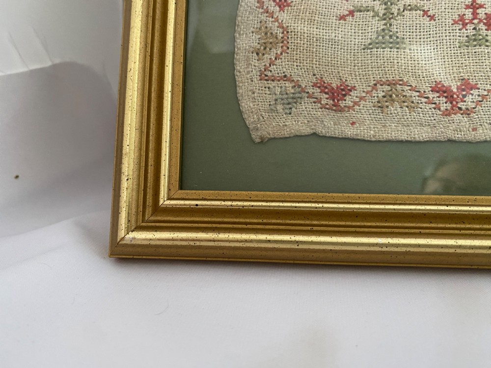 A framed 1839 Victorian needlework sampler featuring an embroidered verse, central house motif, floral trees, and the name Jane Dorrin on natural linen. View V