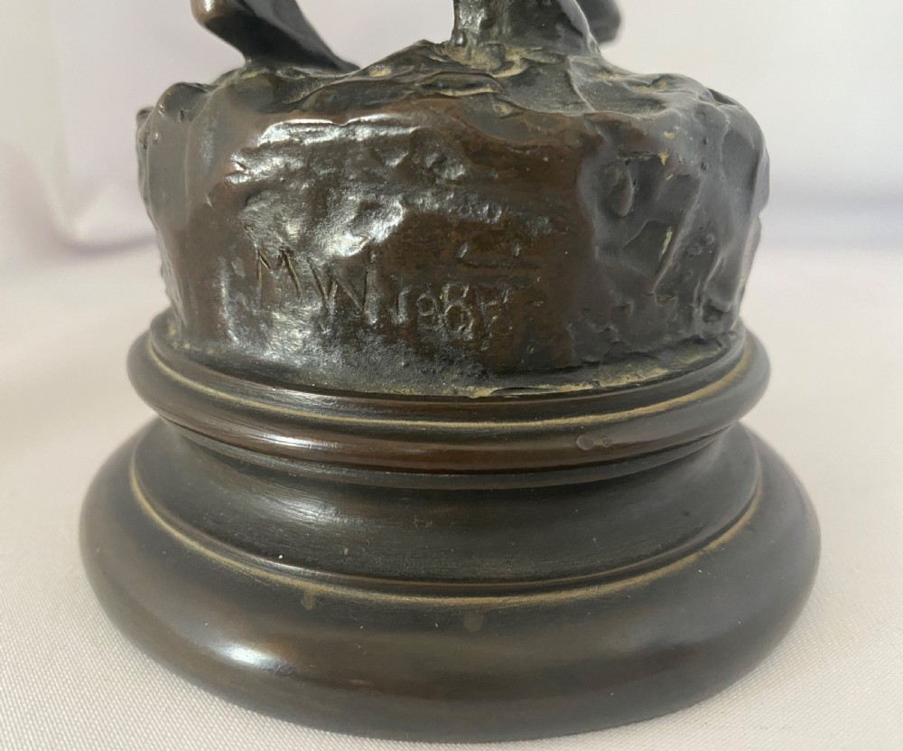A dark patinated bronze figural group depicting two children in dynamic motion standing atop a moulded circular base. View VI