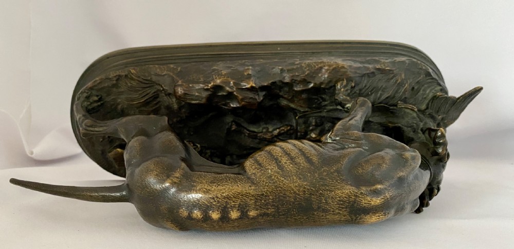A nineteenth-century dark patinated bronze sculpture depicting a muscular gun dog retrieving a game bird on a moulded oval base. View VII