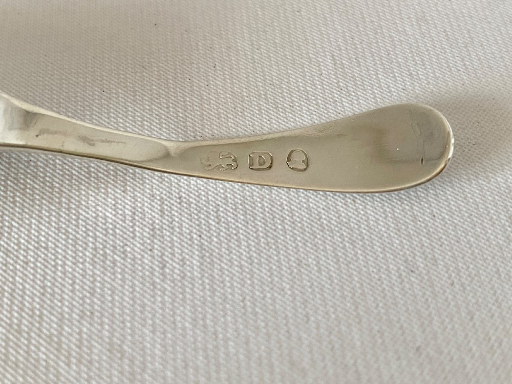 An antique sterling silver caddy spoon featuring an oval bowl with bright-cut engraved borders and a monogrammed handle. View VI