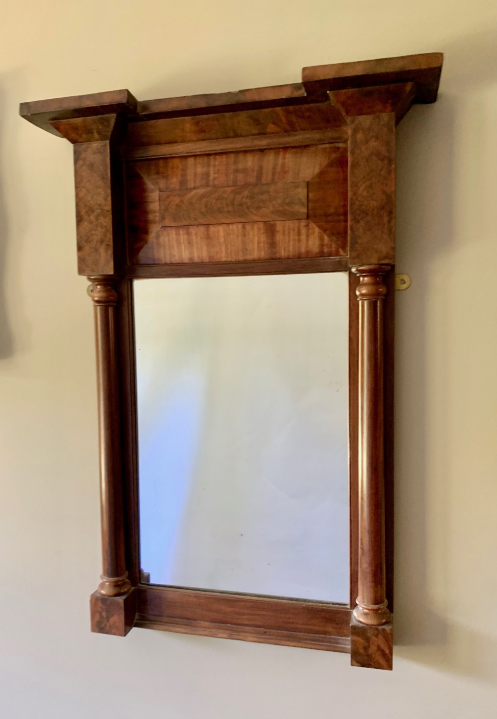 A Regency mahogany pier mirror featuring an upper frieze with flame mahogany veneer, flanked by turned half-columns and topped with a projecting cornice. View IV