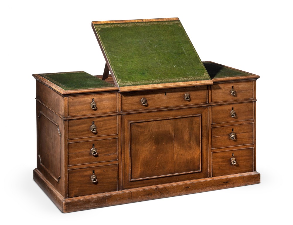 An 18th-century George III Chippendale mahogany pedestal desk featuring a green leather inset writing surface, flame mahogany drawer fronts, and brass drop handles. View II
