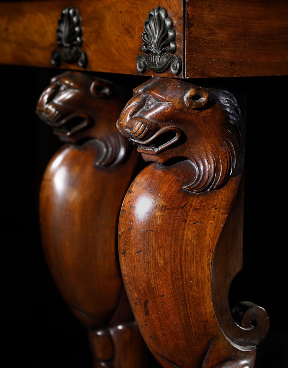 An Irish Regency mahogany serving table featuring four carved lion monopodium legs, dual plinth bases, and a brass gallery rail. View III