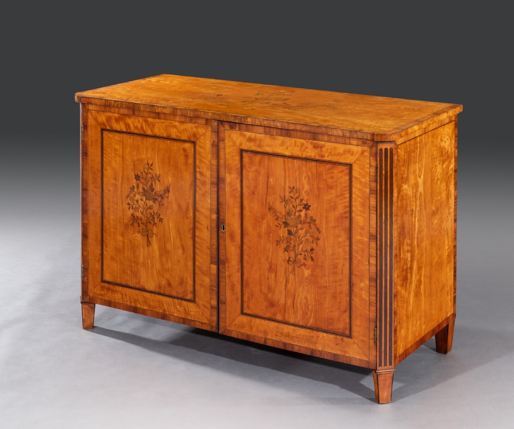 A late 18th-century George III satinwood cabinet featuring floral marquetry inlaid double doors, crossbanded borders, fluted pilasters, and square tapered feet. View II