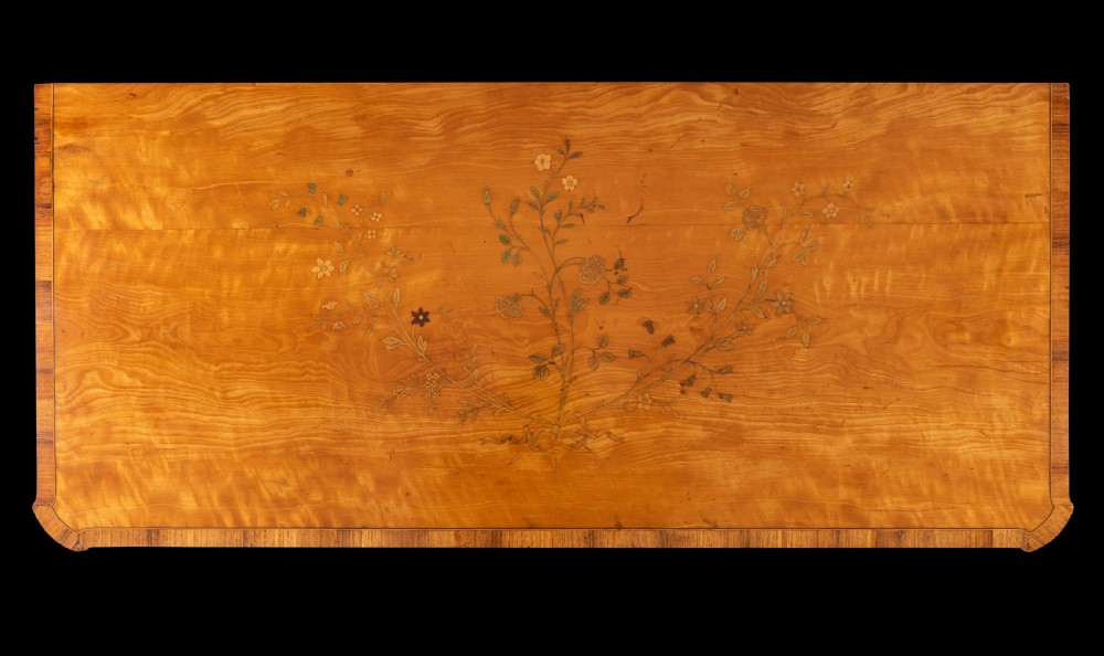 A late 18th-century George III satinwood cabinet featuring floral marquetry inlaid double doors, crossbanded borders, fluted pilasters, and square tapered feet. View III