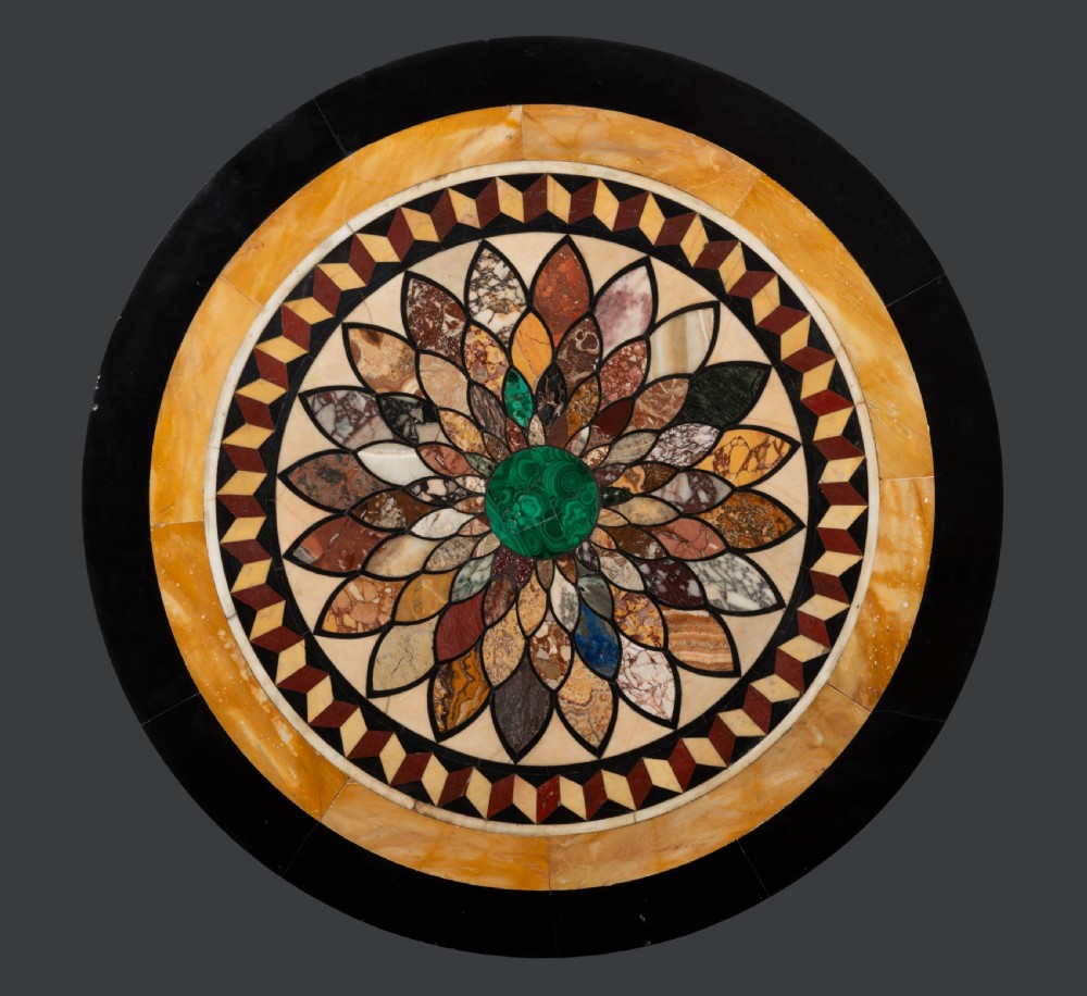 A circular William IV centre table featuring a floral specimen marble inlaid top supported on a fluted giltwood pedestal base with scroll legs. View II