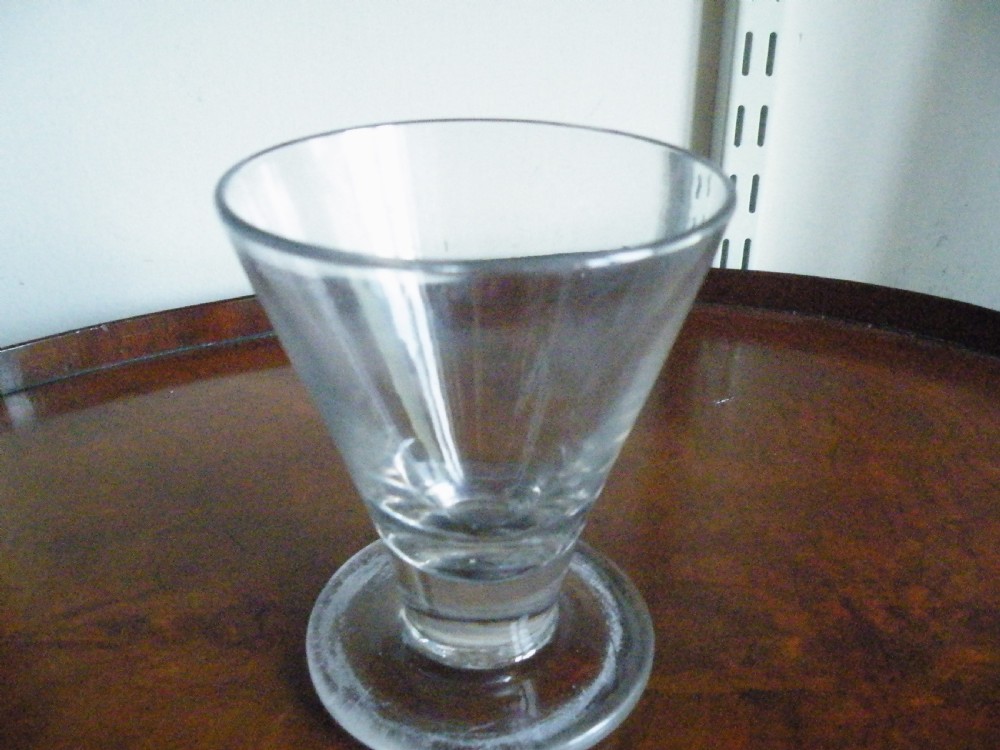 A nineteenth-century clear glass sweetmeat glass featuring a wide conical flared bowl, a short sturdy stem, and a flat circular foot. View II