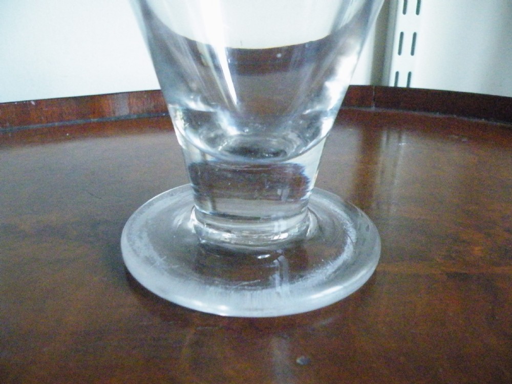 A nineteenth-century clear glass sweetmeat glass featuring a wide conical flared bowl, a short sturdy stem, and a flat circular foot. View III