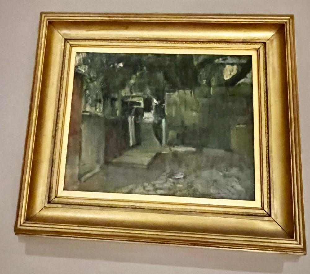 A framed oil painting on canvas depicting a dark garden pathway in muted green tones within a broad gilded wooden frame.