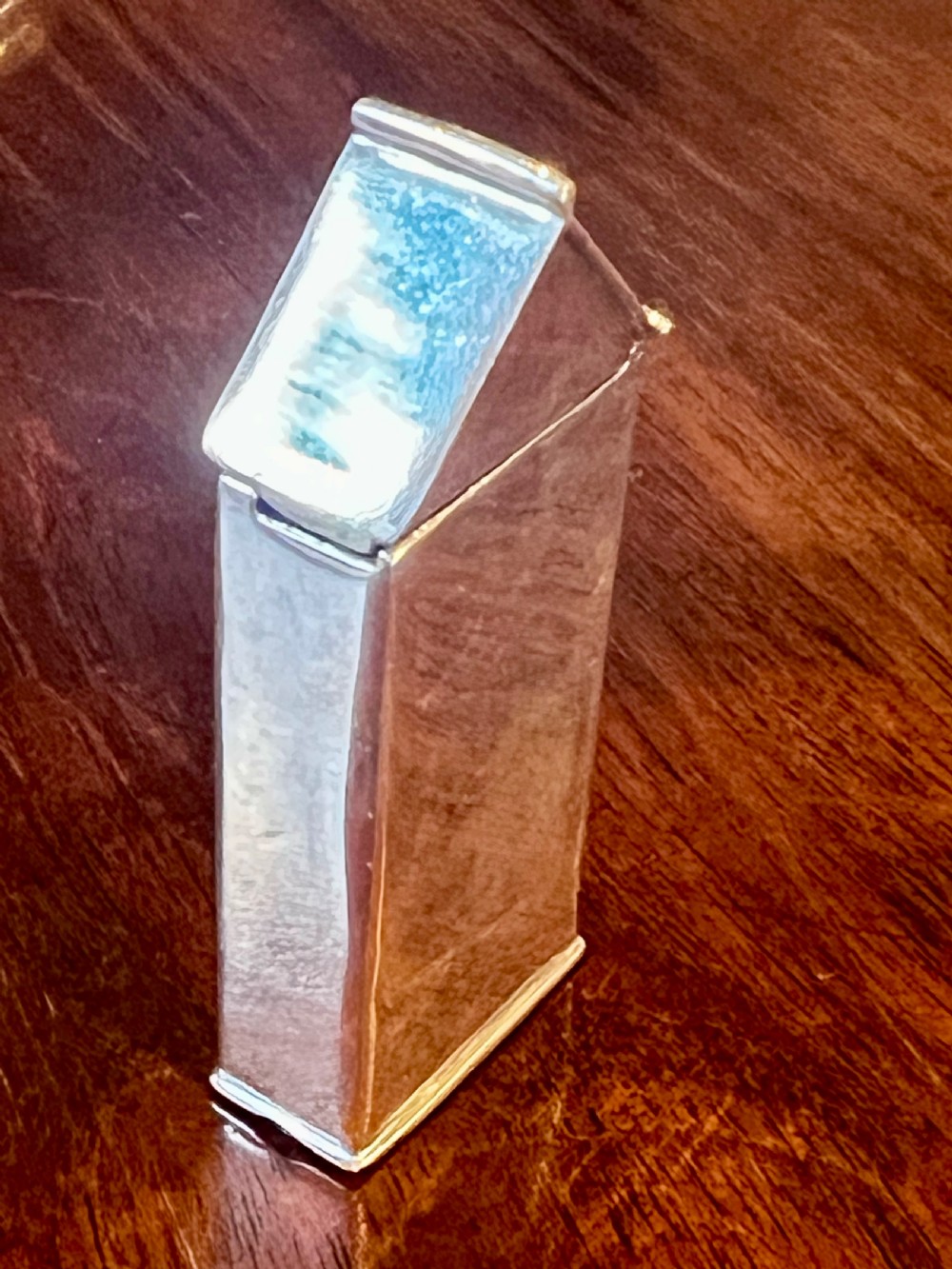 A small vertical silver vesta case shaped like a sentry box, featuring a painted enamel depiction of a guardsman on the front. View III