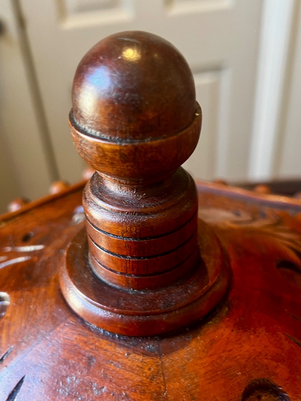 An octagonal wooden postal box featuring carved detailing on the domed roof, a brass letter slot, and a hinged locking door. View X