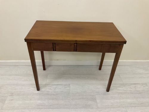 fig 2. An Edwardian mahogany fold-over tea table with straight tapered legs and a rectangular hinged top shown in a closed position against a plain neutral background.