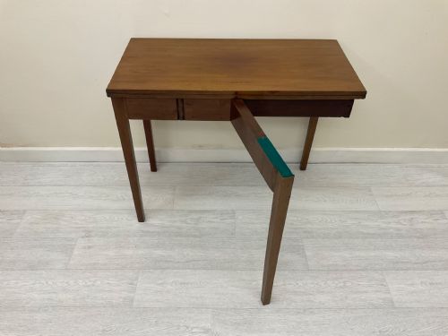 fig 3. An Edwardian mahogany fold-over tea table with straight tapered legs and a rectangular hinged top shown in a closed position against a plain neutral background.