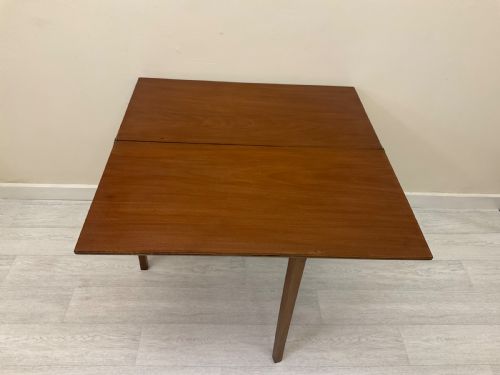 fig 4. An Edwardian mahogany fold-over tea table with straight tapered legs and a rectangular hinged top shown in a closed position against a plain neutral background.