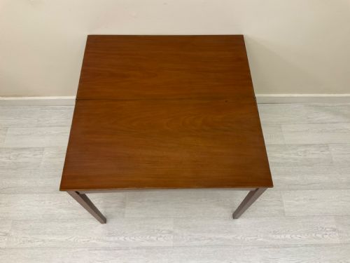 fig 7. An Edwardian mahogany fold-over tea table with straight tapered legs and a rectangular hinged top shown in a closed position against a plain neutral background.