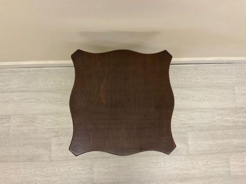 fig 1. A dark mahogany Victorian tilt-top side table resting on a turned central pedestal with three cabriole legs, shown with the top secured in the vertical position.
