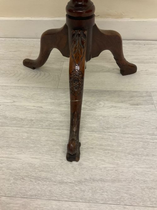 fig 5. A dark mahogany Victorian tilt-top side table resting on a turned central pedestal with three cabriole legs, shown with the top secured in the vertical position.
