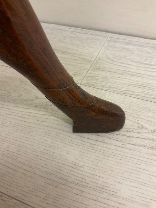 fig 4. A dark mahogany Victorian tilt-top side table resting on a turned central pedestal with three cabriole legs, shown with the top secured in the vertical position.